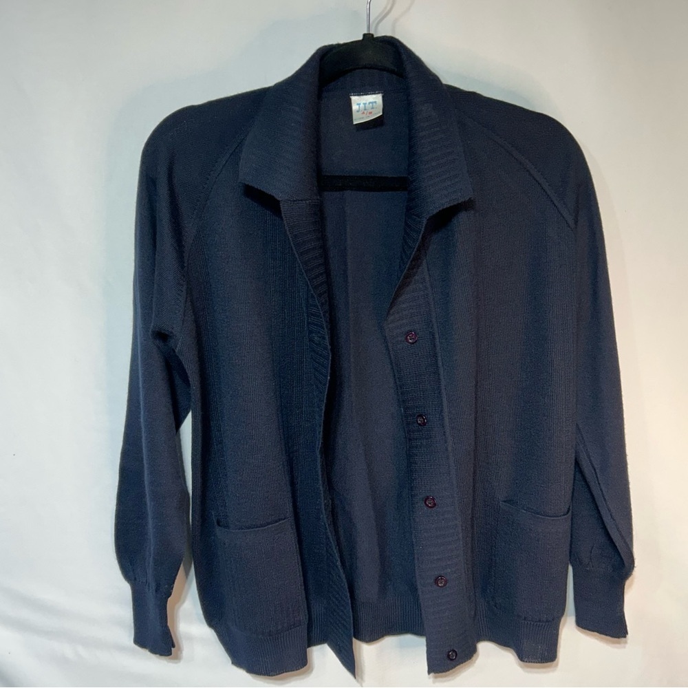 Vintage woman’s 50% wool navy blue cardigan with buttons and collar. Size small
